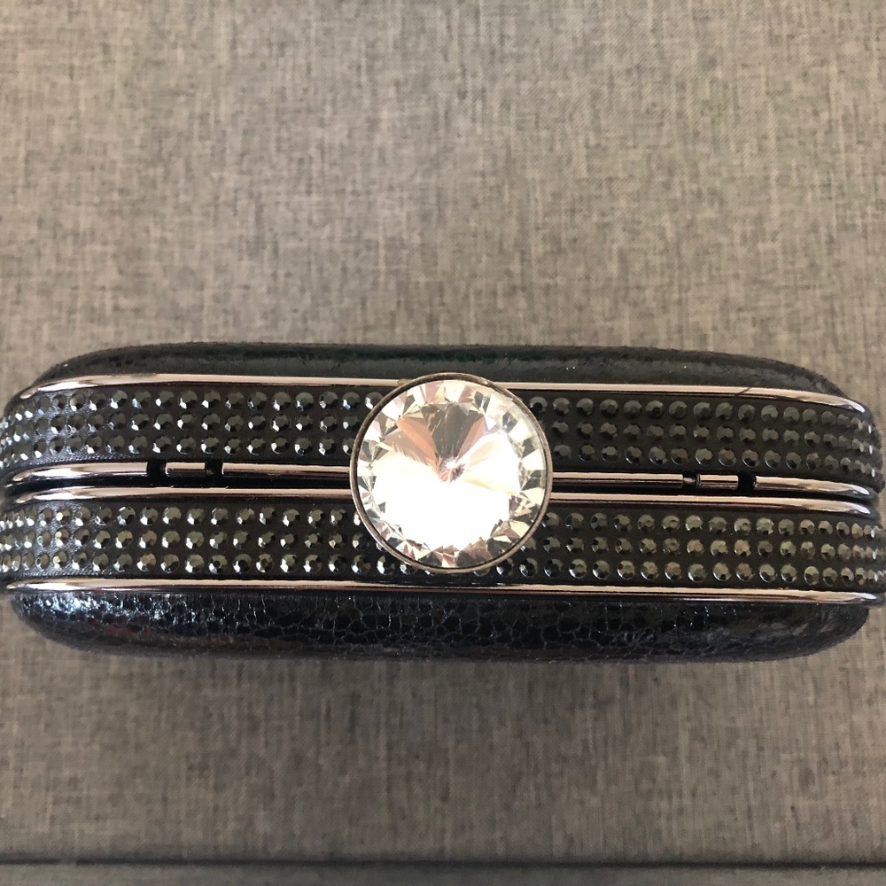 Formal black clutch handbag with snap closure and removeable chain strap